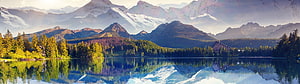 Serene Alpine Lake with Snow-Capped Mountains and Pine Forest Reflection HD wallpaper