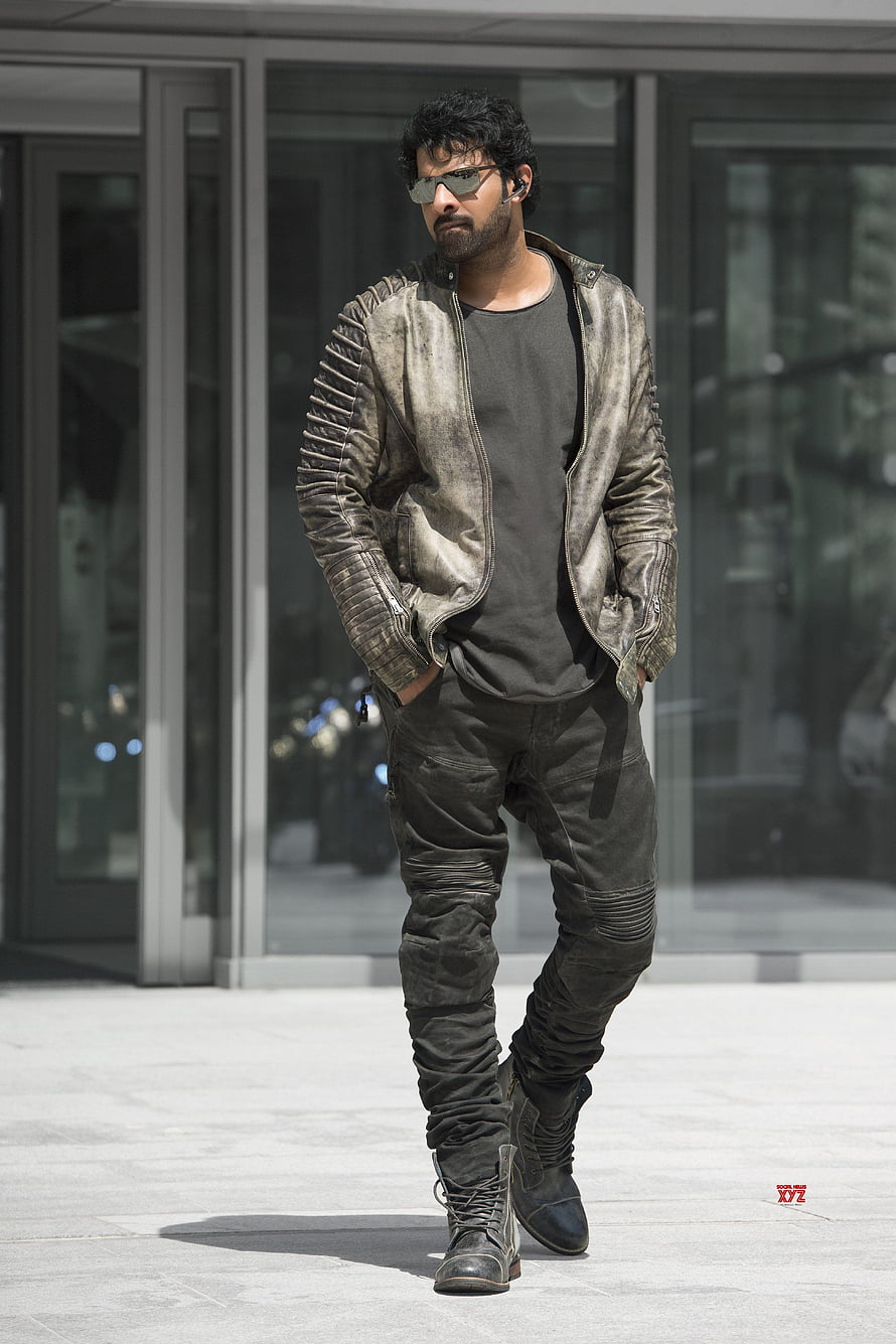 Pawan Kalyan in rugged leather jacket and sunglasses walking outdoors HD phone wallpaper
