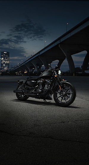 Black Harley-Davidson Fat Bob motorcycle parked under a bridge at night HD phone wallpaper