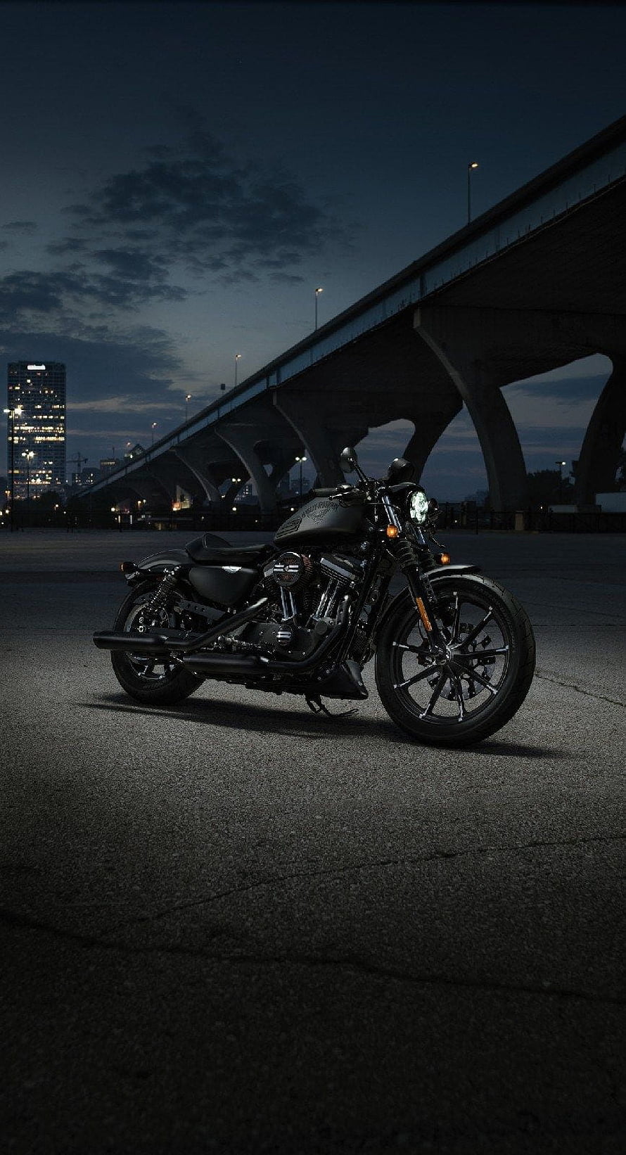 Black Harley-Davidson Fat Bob motorcycle parked under a bridge at night HD phone wallpaper