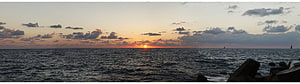 Panoramic Ocean Sunset with Scattered Clouds and Distant Sailboats HD wallpaper