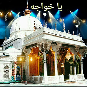 Illuminated white marble shrine with ornate dome and pillars at night HD phone wallpaper