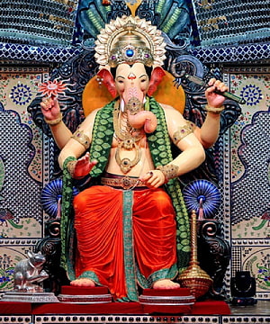 Lalbaugcha Raja Ganesha Murti with Ornate Temple Backdrop and Traditional Attire HD phone wallpaper