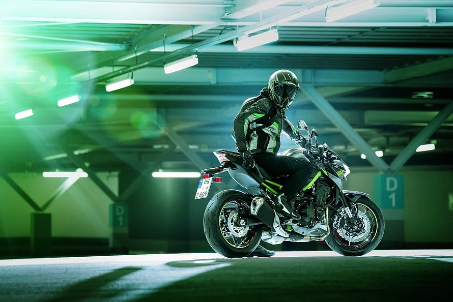 Rider on a Kawasaki Ninja Z900 in a Neon-Lit Underground Parking Garage HD wallpaper