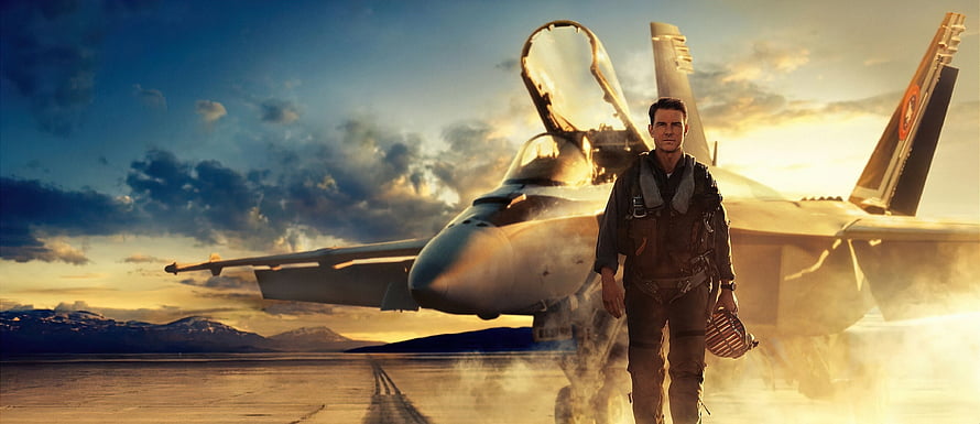Top Gun Maverick Pilot Walking in Front of F-18 Fighter Jet at Sunset HD wallpaper