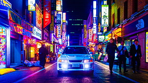 White Mitsubishi Lancer Evolution in Neon-Lit Japanese Street at Night HD wallpaper