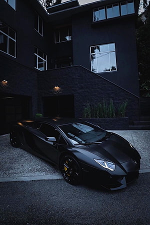 Matte Black Lamborghini Aventador Parked in Front of Modern Dark Residence at Dusk HD phone wallpaper