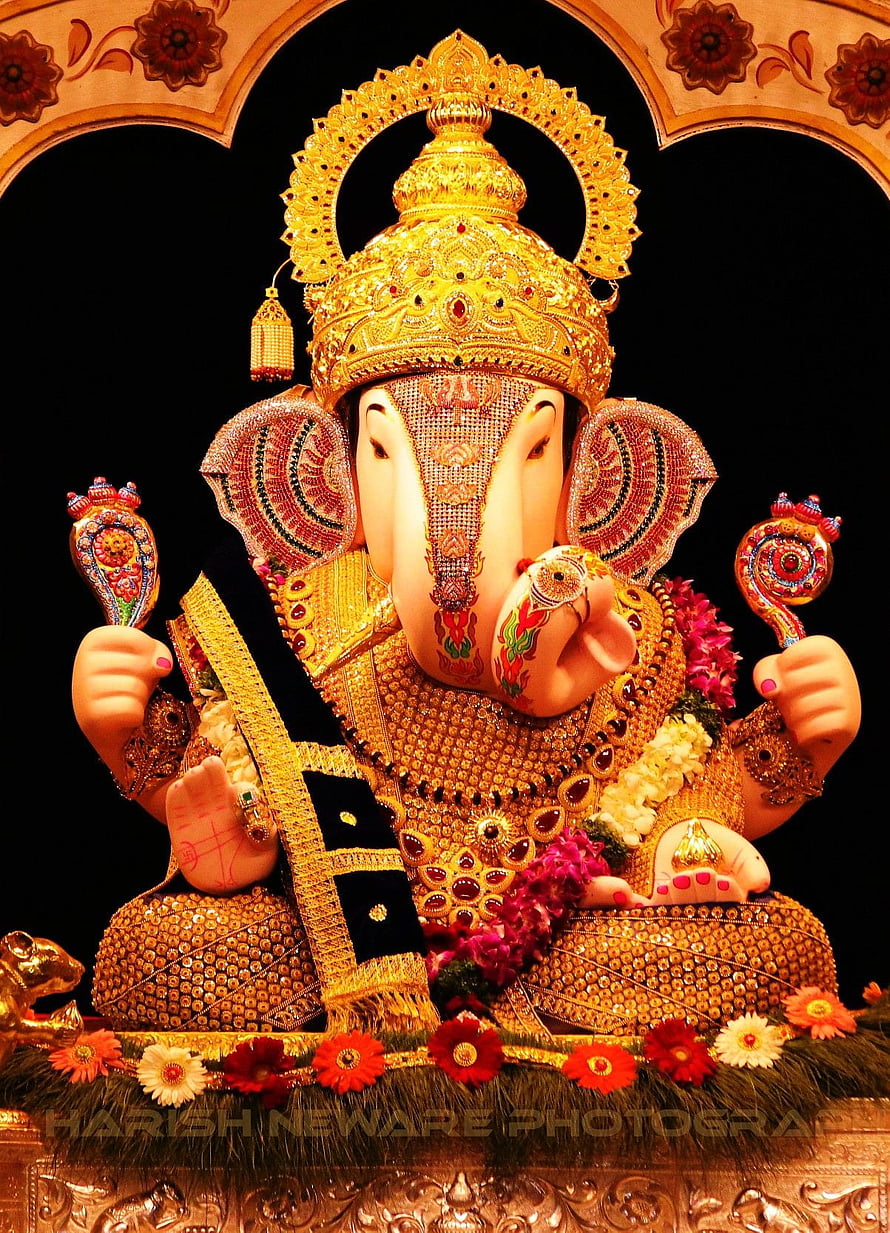 Ornate Golden Ganesha Murti Adorned With Jewels And Floral Garlands HD phone wallpaper