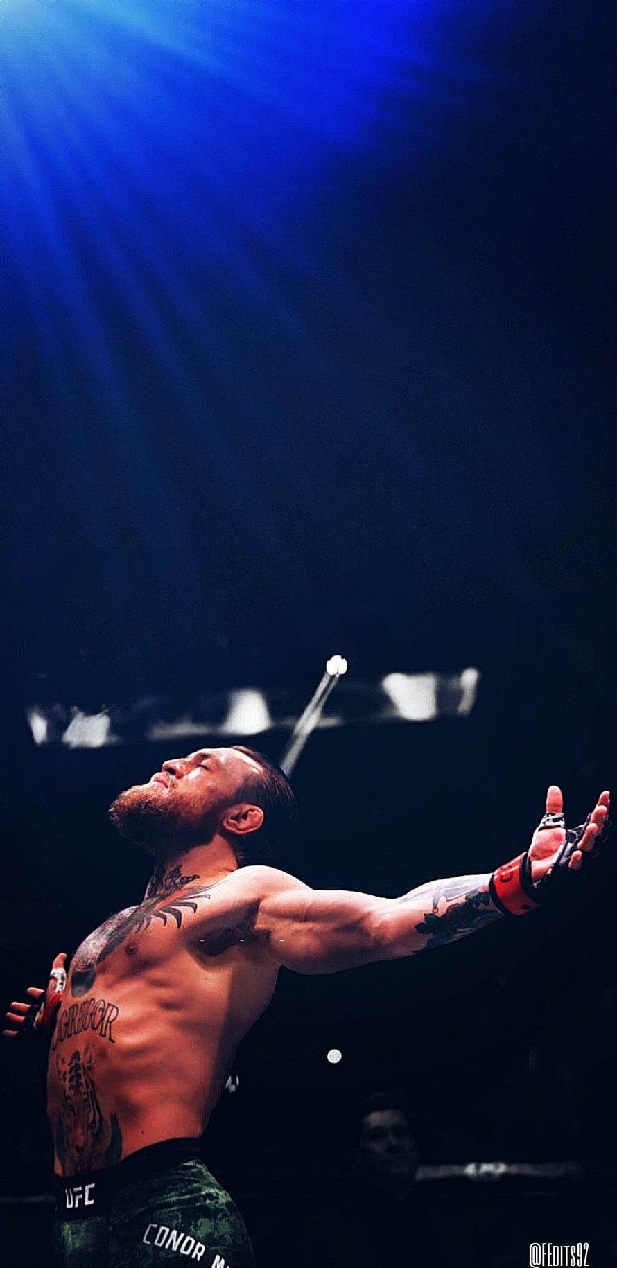 Conor McGregor UFC Fighter Celebrating Victory in the Octagon Under Blue Spotlight HD phone wallpaper