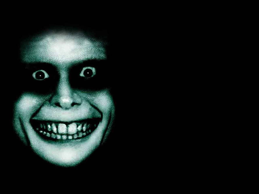 Eerie Glowing Face With Wide Grin in Dark Void HD wallpaper
