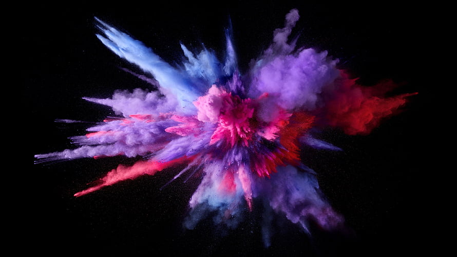 Vibrant Multicolored Powder Explosion Bursting Against a Deep Black Background HD wallpaper