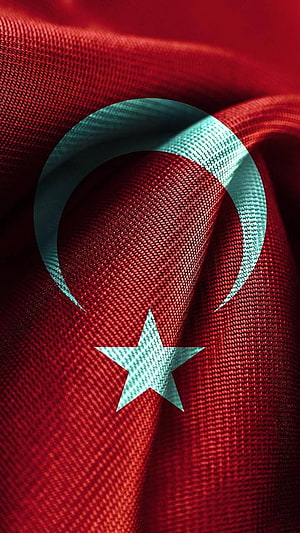 Close-up of the Turkish flag with white crescent and star on red fabric HD phone wallpaper