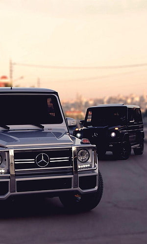Silver and Black Mercedes-Benz G-Class SUVs Driving on Road at Sunset HD phone wallpaper