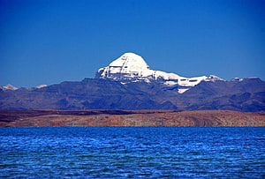 Mount Kailash Rising Above Lake Mansarovar in the Himalayas HD wallpaper