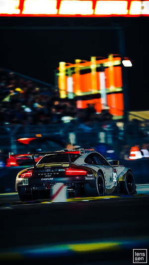 Porsche 919 Hybrid race car speeding on the track during the Le Mans night endurance race HD phone wallpaper