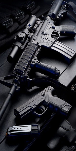 Tactical AR-15 Rifle and Glock 19 Pistol with Scope and Magazine on Dark Surface HD phone wallpaper