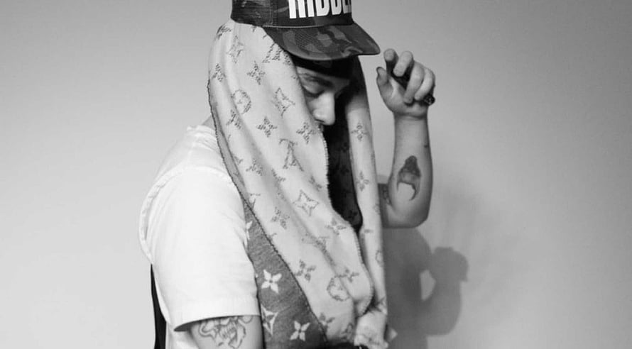 Black and white portrait of a person wearing a Louis Vuitton scarf and a cap with tattoos HD wallpaper