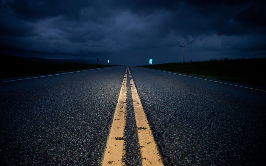 Empty Highway Stretching Into Dark Stormy Horizon With Yellow Lines HD wallpaper