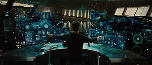 Tony Stark Interacting with Holographic Car Designs in High-Tech Workshop HD wallpaper