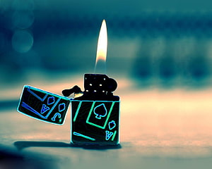 Glowing Playing Card Lighter with Bright Flame on Blurred Background HD wallpaper