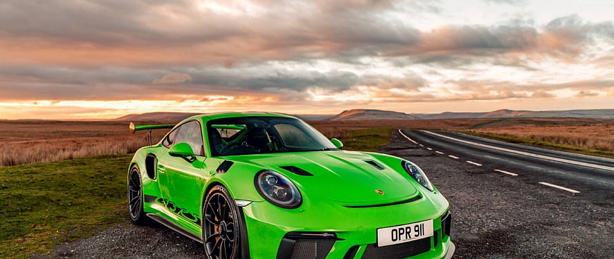 Vibrant Green Porsche 911 GT3 RS Parked on a Rural Road at Sunset HD wallpaper