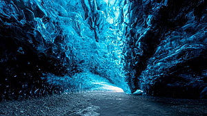 Vibrant Blue Ice Cave Interior with Glowing Crystalline Walls and Rocky Path HD wallpaper