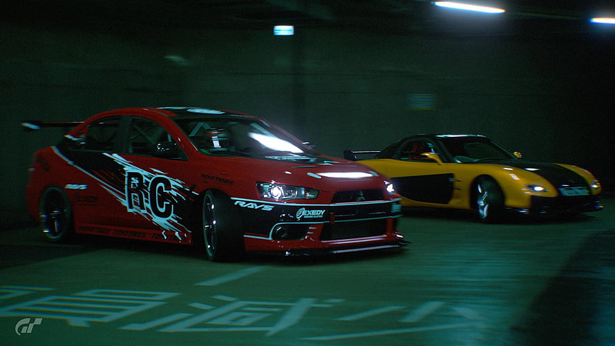 Red Mitsubishi Lancer Evolution and Yellow Mazda RX-7 Drifting in a Dark Underground Parking Garage HD wallpaper