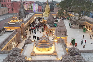 Kashi Vishwanath Temple Complex at Dusk with Golden Shikhara and Crowded Courtyard HD wallpaper