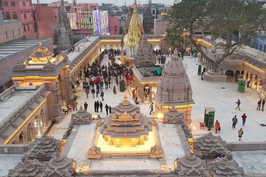 Kashi Vishwanath Temple Complex at Dusk with Golden Shikhara and Crowded Courtyard HD wallpaper