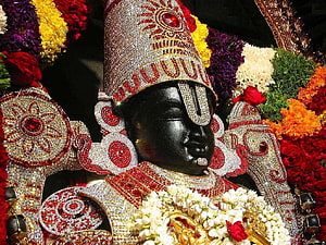 Ornate Black Stone Idol of Lord Ayyappa Adorned with Jewels and Flowers HD wallpaper