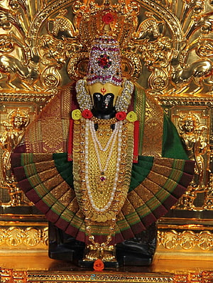 Ornate Mahalaxmi Deity Idol Adorned in Gold Jewelry and Traditional Silk Garments HD phone wallpaper