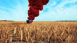 PUBG Red Smoke Signal Rising from a Supply Crate in a Golden Wheat Field HD wallpaper