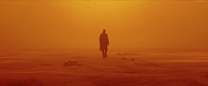 Blade Runner 2049 Lone Figure Walking Through Orange Dusty Desert Landscape HD wallpaper