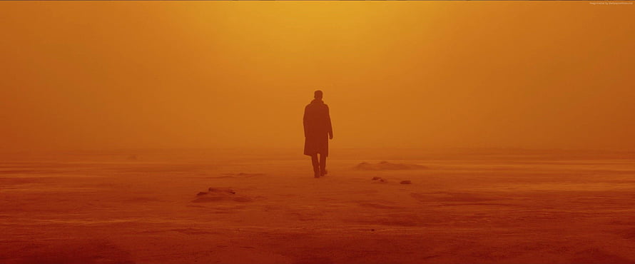 Blade Runner 2049 Lone Figure Walking Through Orange Dusty Desert Landscape HD wallpaper