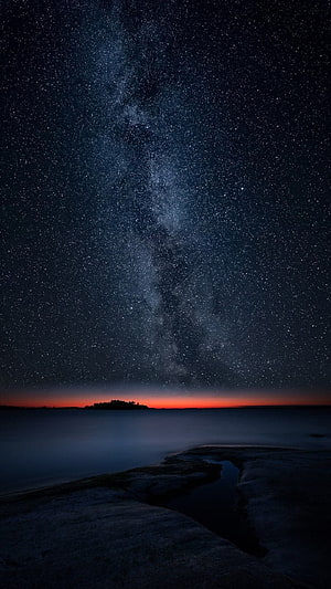 Milky Way Galaxy Over Calm Ocean With Orange Horizon Glow HD phone wallpaper