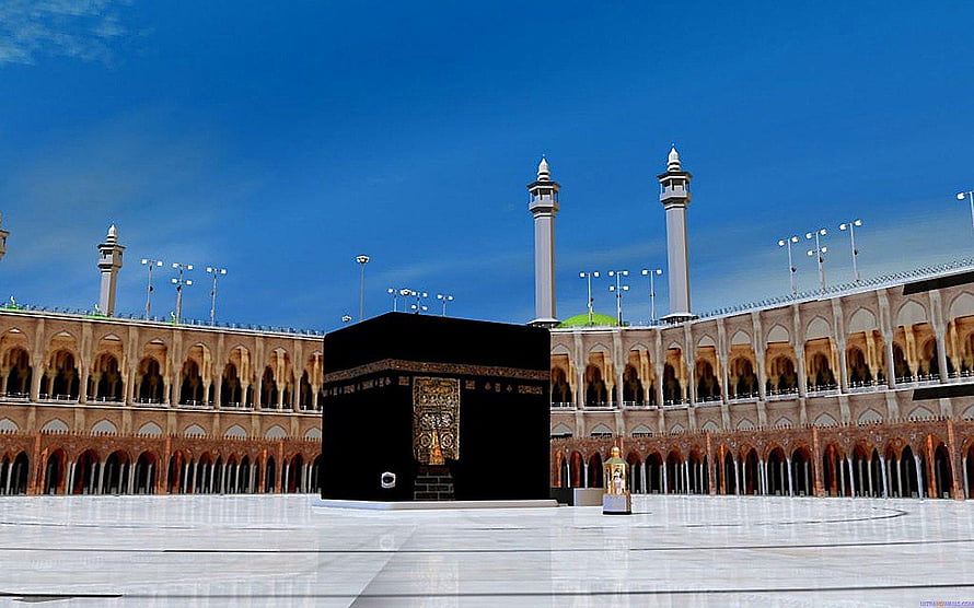 The Kaaba in Mecca, Saudi Arabia, surrounded by the Grand Mosque under a clear blue sky HD wallpaper
