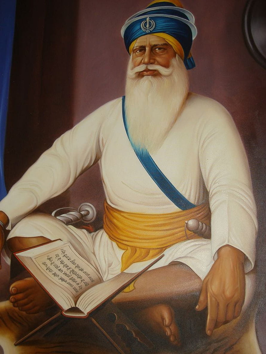 Portrait of Guru Nanak Dev Ji Reading Holy Scripture with Khanda Symbol HD phone wallpaper