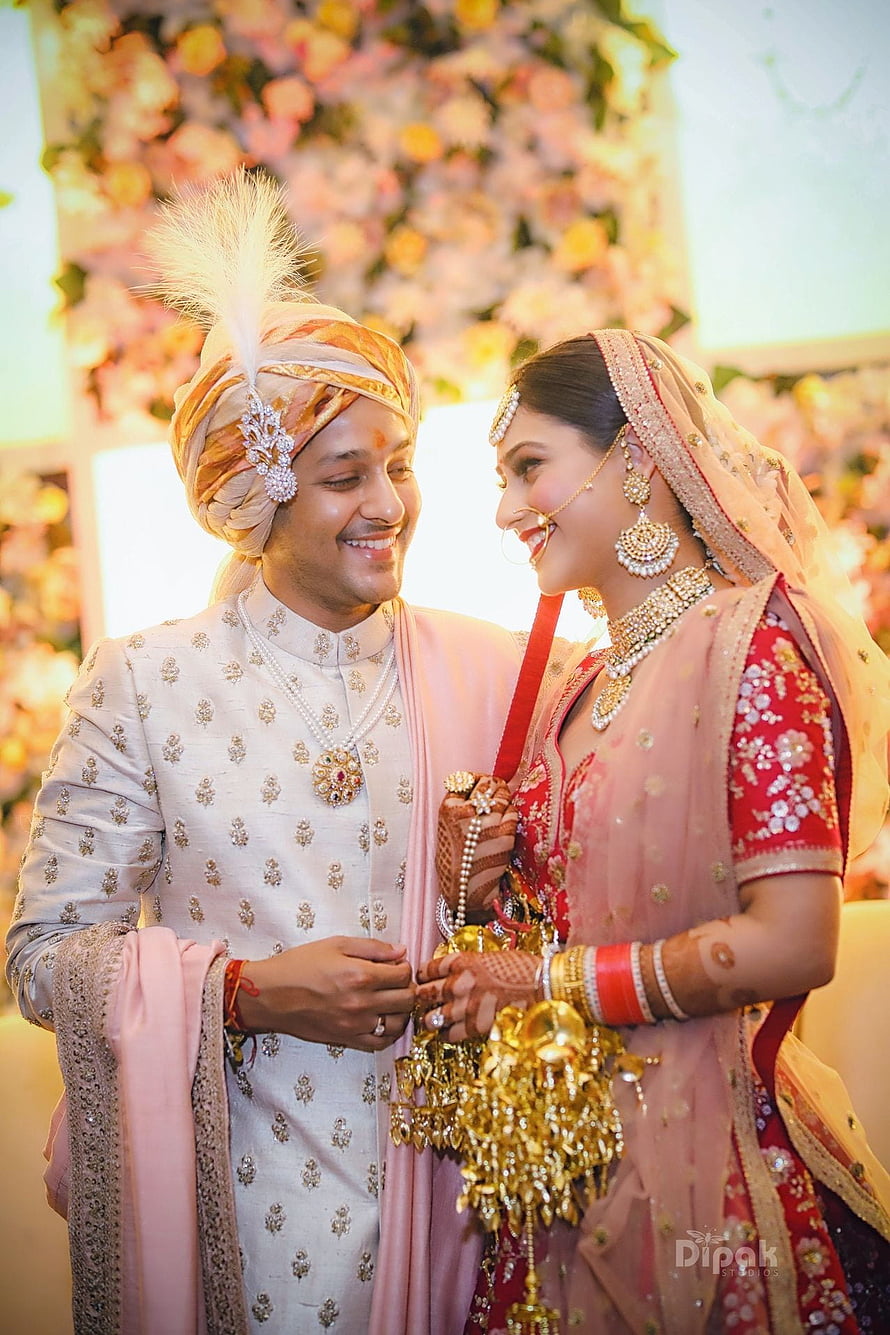 Indian Bride and Groom Sharing a Joyful Moment in Traditional Wedding Attire HD phone wallpaper