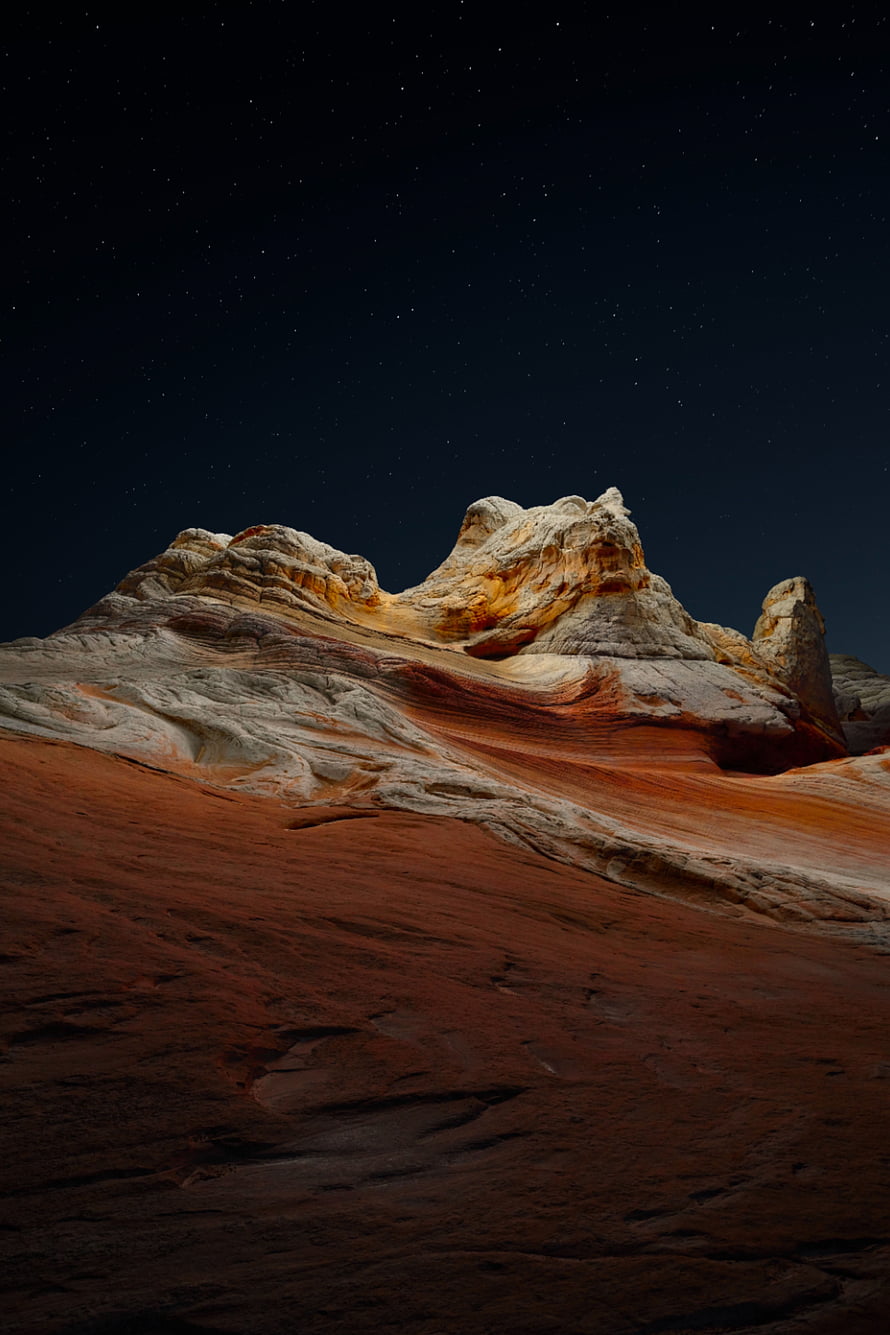 Dramatic Red Rock Formation Under a Starry Night Sky in the Desert HD phone wallpaper