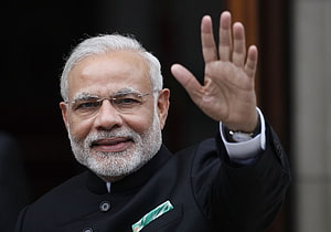 Narendra Modi Waving in Black Suit with White Pocket Square HD wallpaper