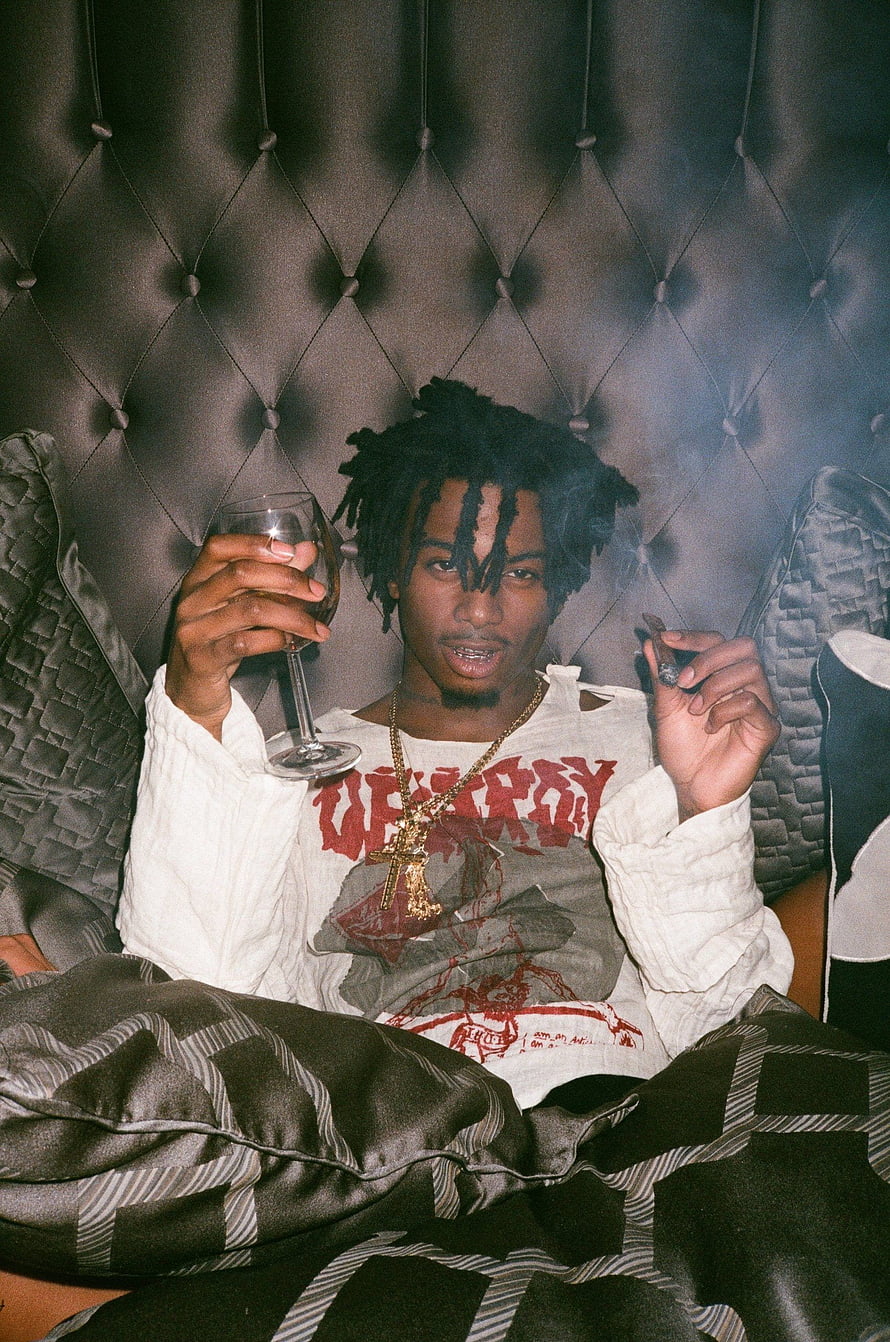 Playboi Carti Holding Wine Glass and Cigar in Tufted Headboard Setting HD phone wallpaper