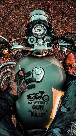 Royal Enfield Bullet Tank Close-Up With Rider's Gloved Hand and Keychain HD phone wallpaper