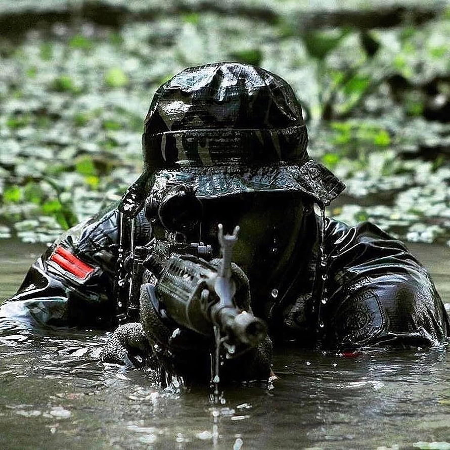 Indonesian Army Soldier in Camouflage Gear Holding Rifle in Shallow Water HD phone wallpaper