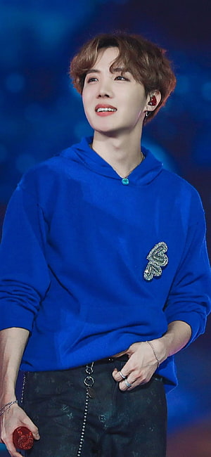 J-Hope from BTS in a blue hoodie with butterfly brooch on stage HD phone wallpaper