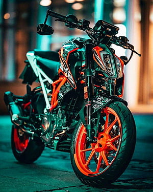 KTM Duke 390 motorcycle with orange wheels and black body parked on a street at night HD phone wallpaper