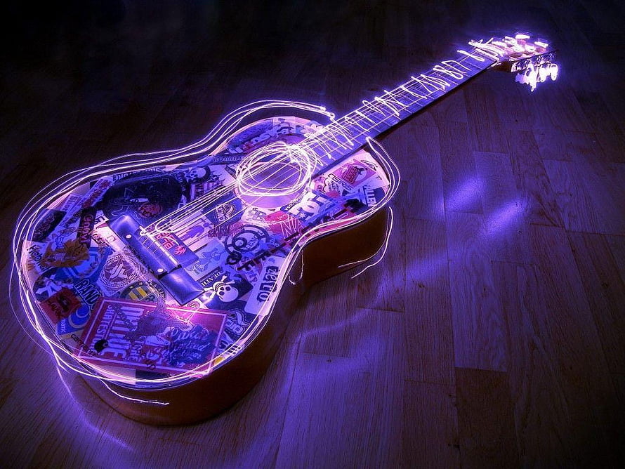 Glowing Acoustic Guitar with Sticker Collage and Neon Light Trails on Wooden Floor HD wallpaper