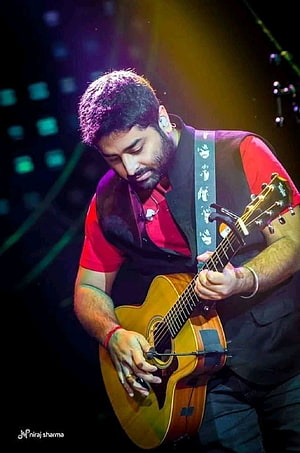 Arijit Singh Playing Acoustic Guitar on Stage in Red Shirt and Black Vest HD phone wallpaper