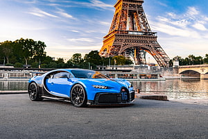 Blue Bugatti Chiron Pur Sport parked on the Seine with the Eiffel Tower in Paris at sunset HD wallpaper