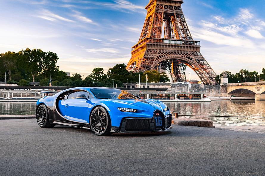 Blue Bugatti Chiron Pur Sport parked on the Seine with the Eiffel Tower in Paris at sunset HD wallpaper