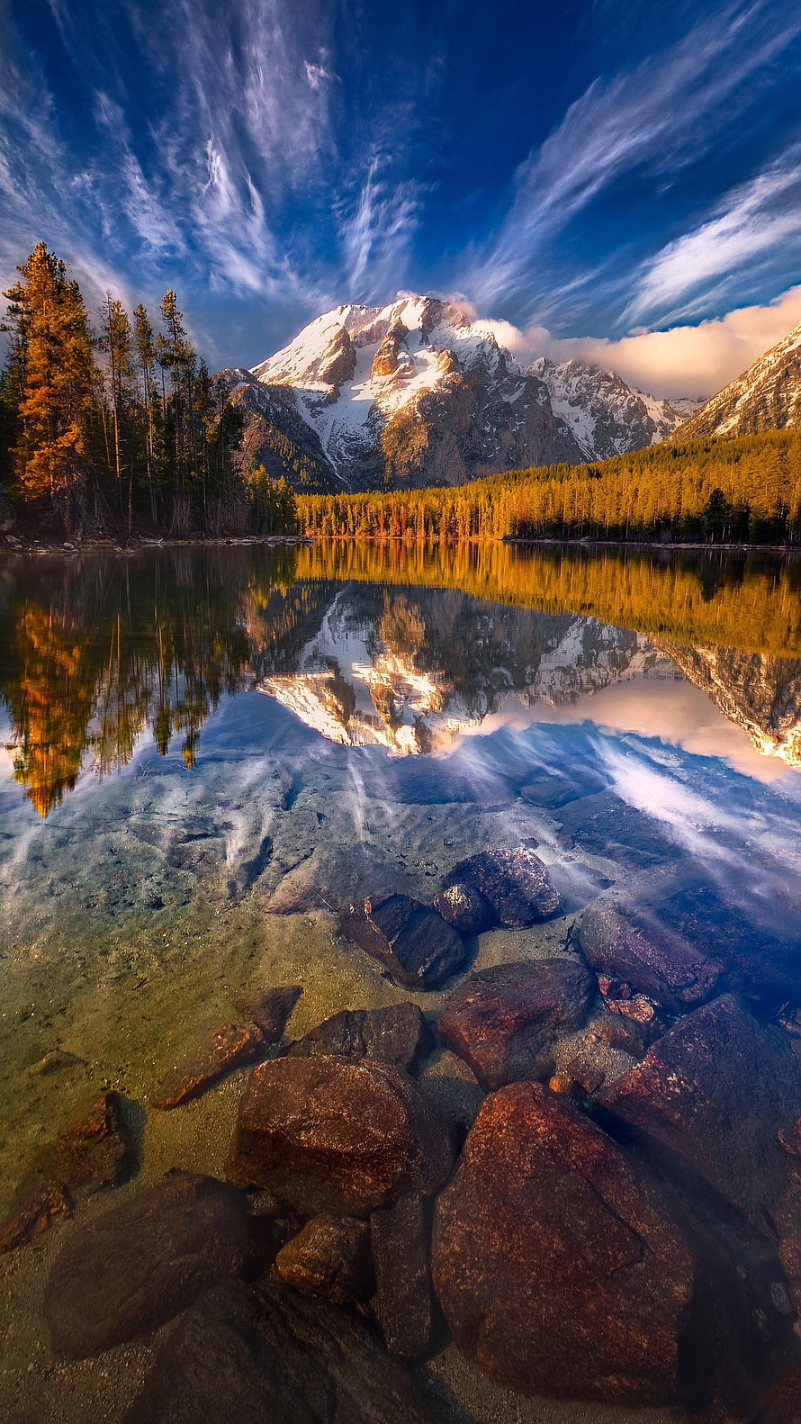 Snow-Capped Mountain Peak Reflected in a Clear Alpine Lake with Rocky Shoreline HD phone wallpaper